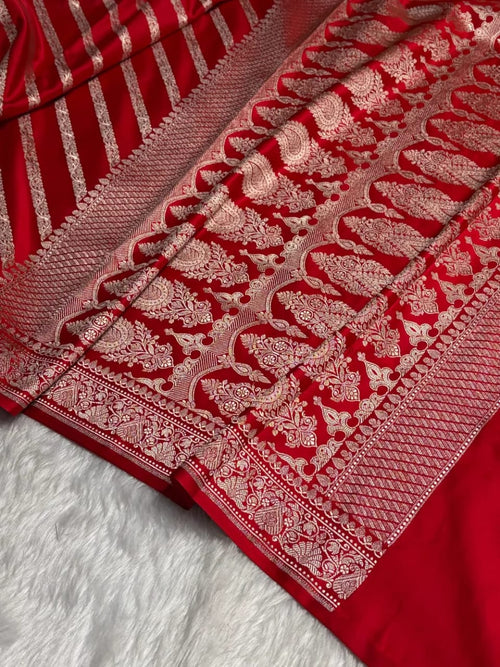 Red fabric with intricate white patterns on a white background