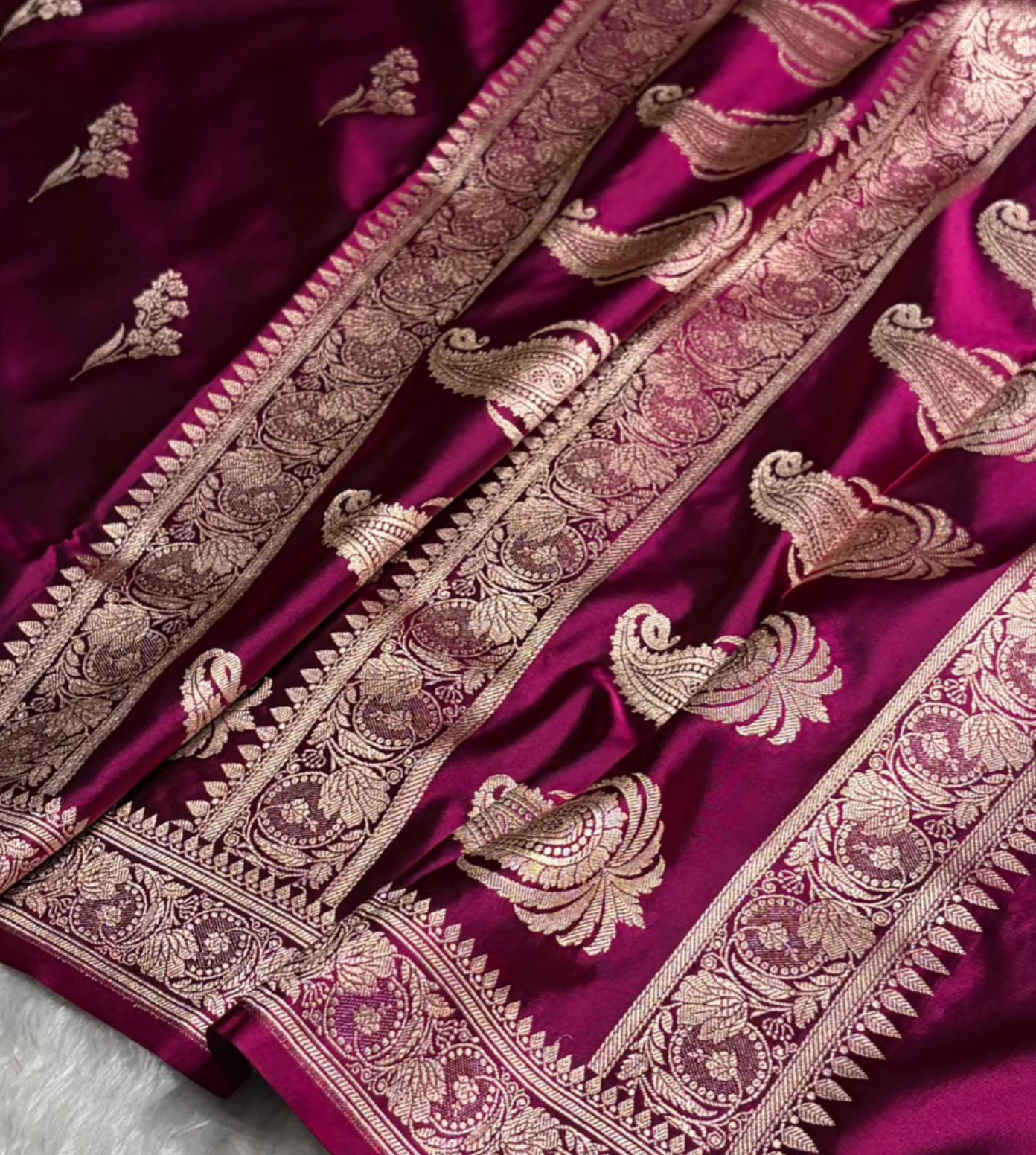 Close-up of a purple fabric with intricate gold embroidery