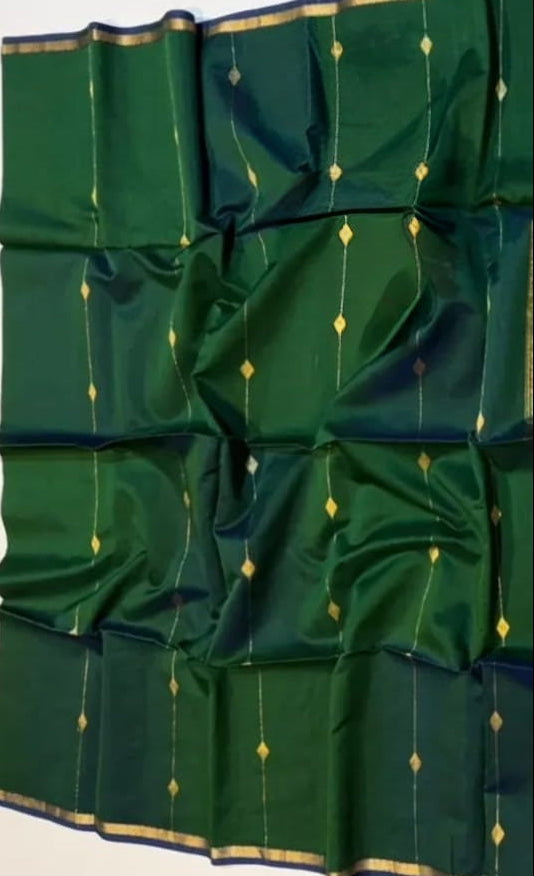 Green fabric with gold patterns on a white background