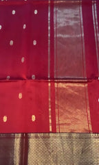 Red fabric with gold patterns and a checkered border