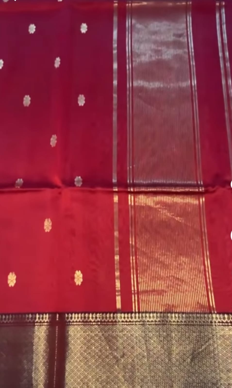 Red fabric with gold patterns and a checkered border