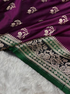 Purple fabric with white floral patterns and green border on a white background