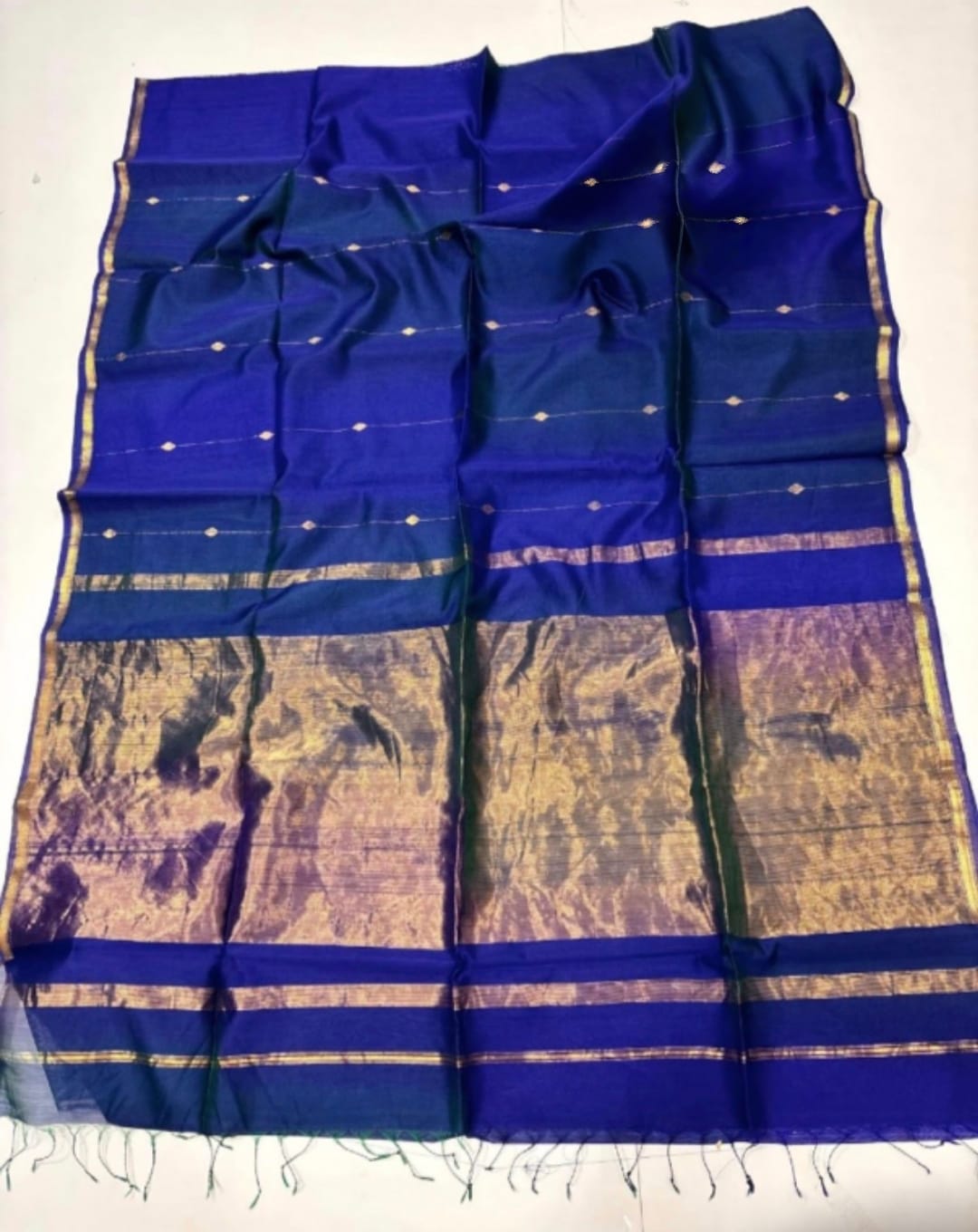 Blue and gold saree with a white background