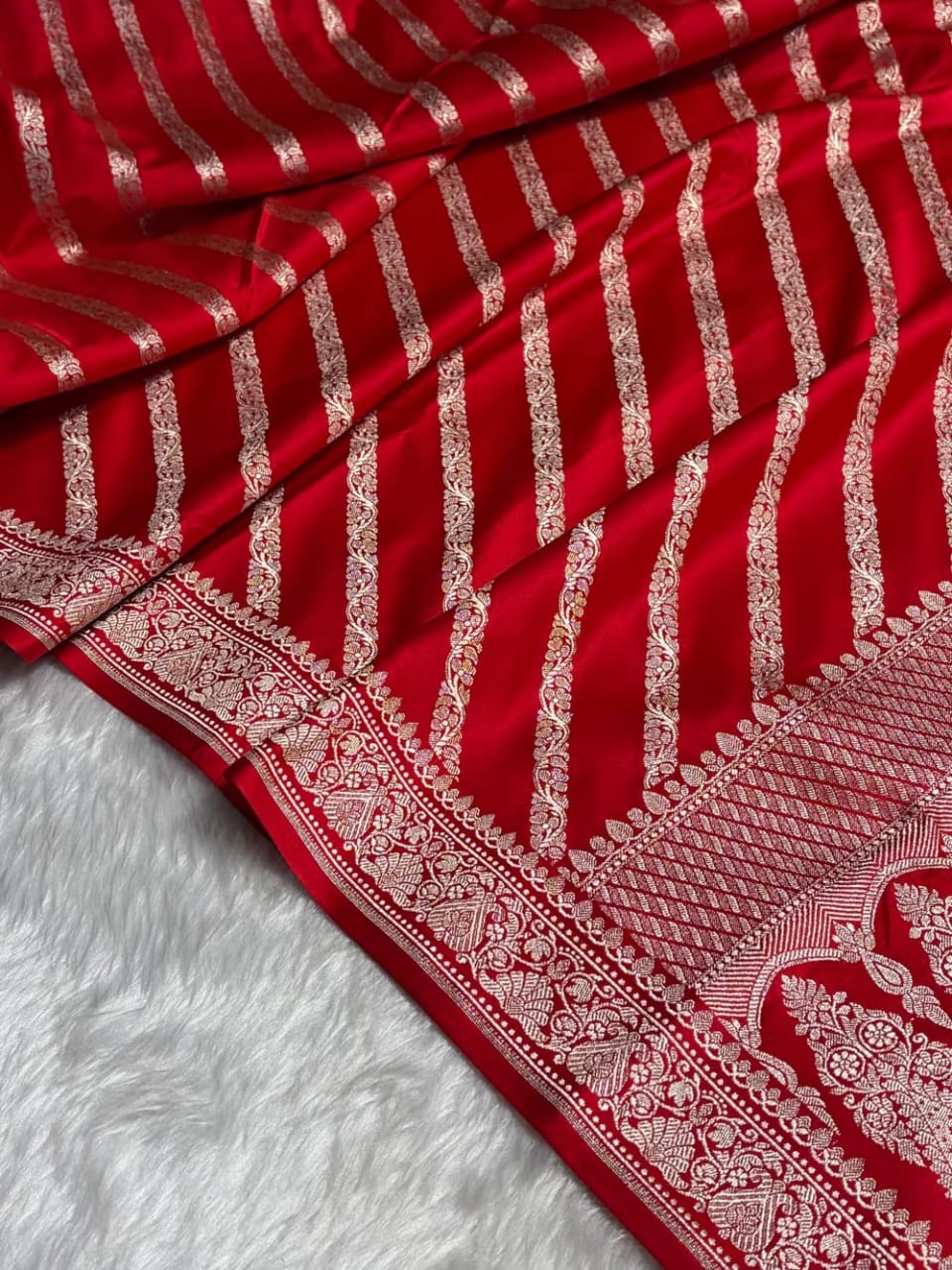 Red fabric with white patterns on a white background