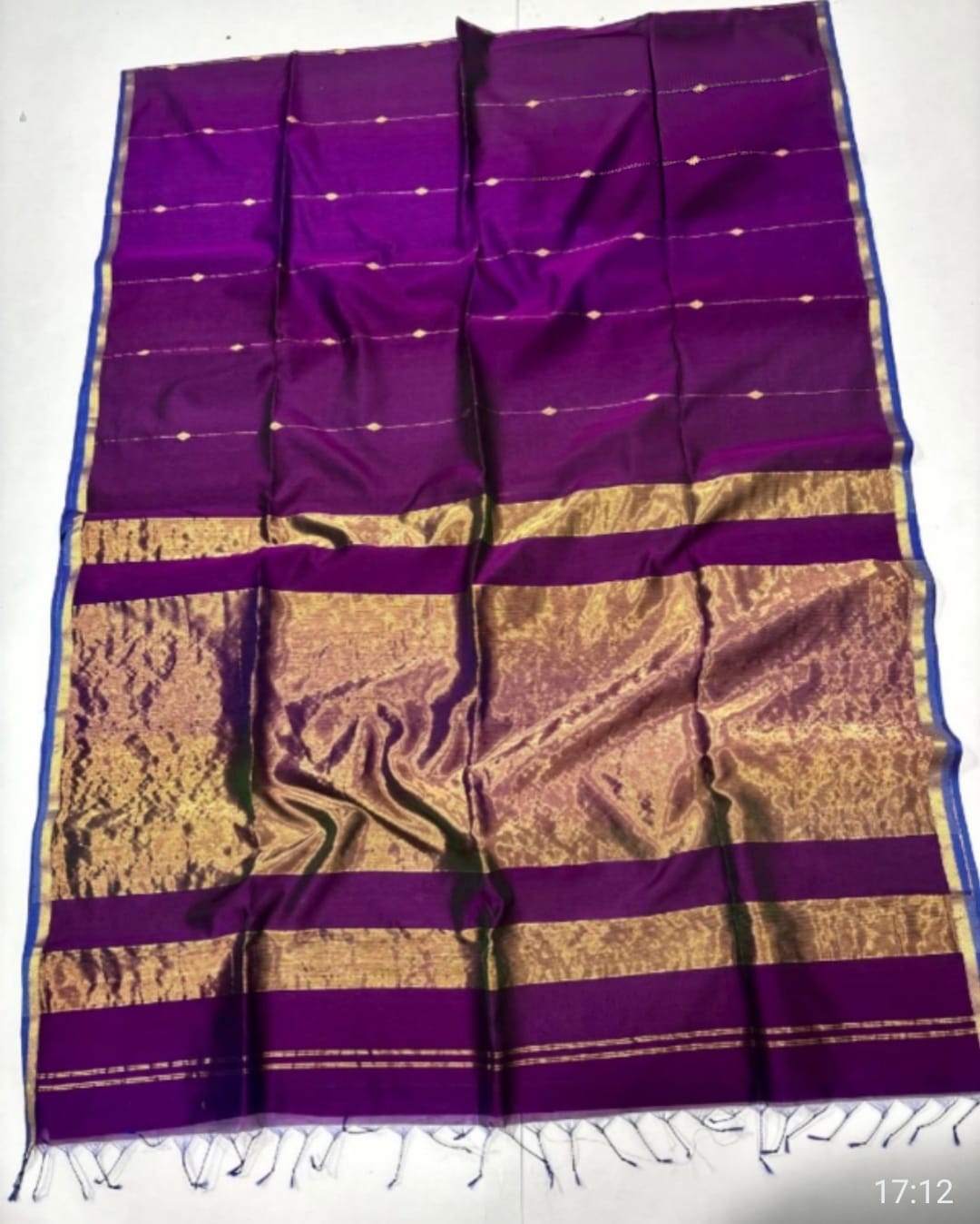 Purple and gold saree with a white background