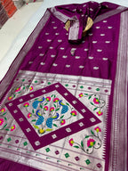 Purple and white saree with floral patterns on a plain background