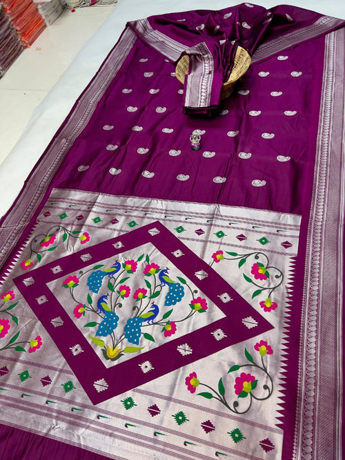 Purple and white saree with floral patterns on a plain background