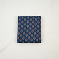 Folded blue fabric with floral pattern on a white background