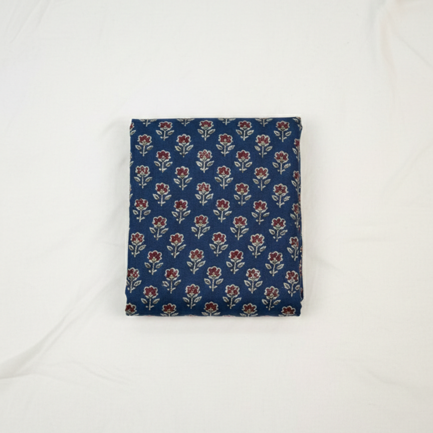 Folded blue fabric with floral pattern on a white background