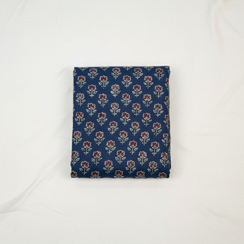 Folded blue fabric with floral pattern on a white background