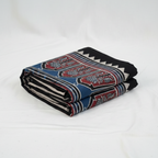 Folded blanket with a pattern on a white background