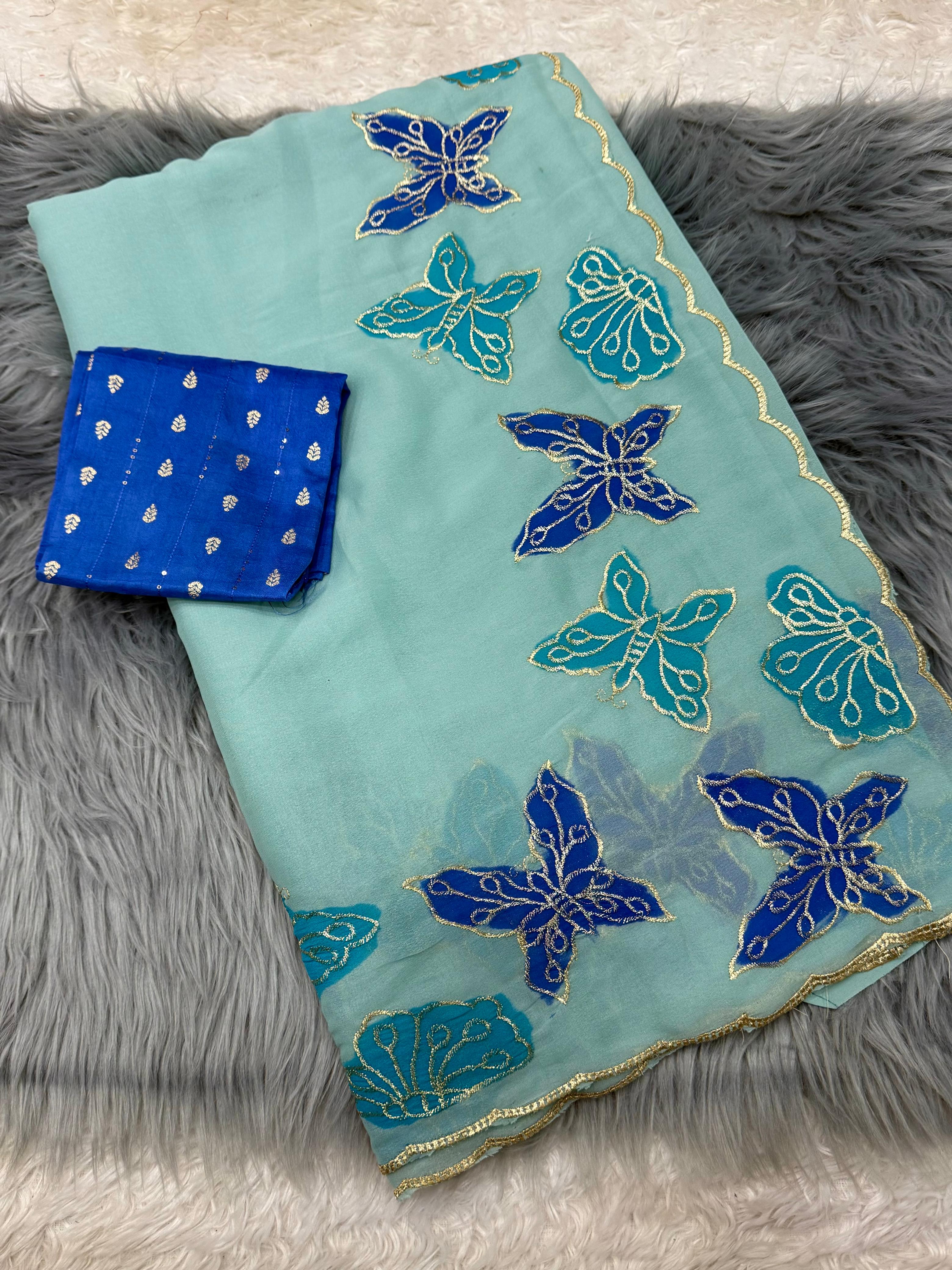 Teal fabric with blue butterfly patterns on a gray textured surface