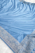 Light blue fabric with intricate patterns on a white background