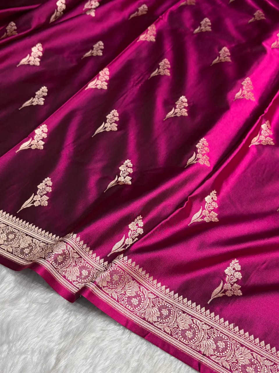 Purple fabric with gold floral patterns on a white background