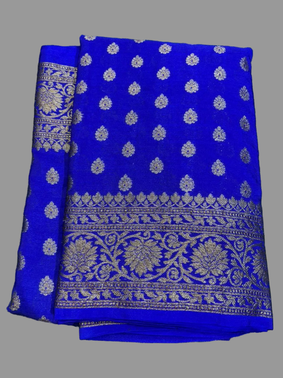 Blue fabric with silver patterns on a green grass background
