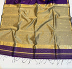 Purple and gold saree with a basket of flowers on a white background