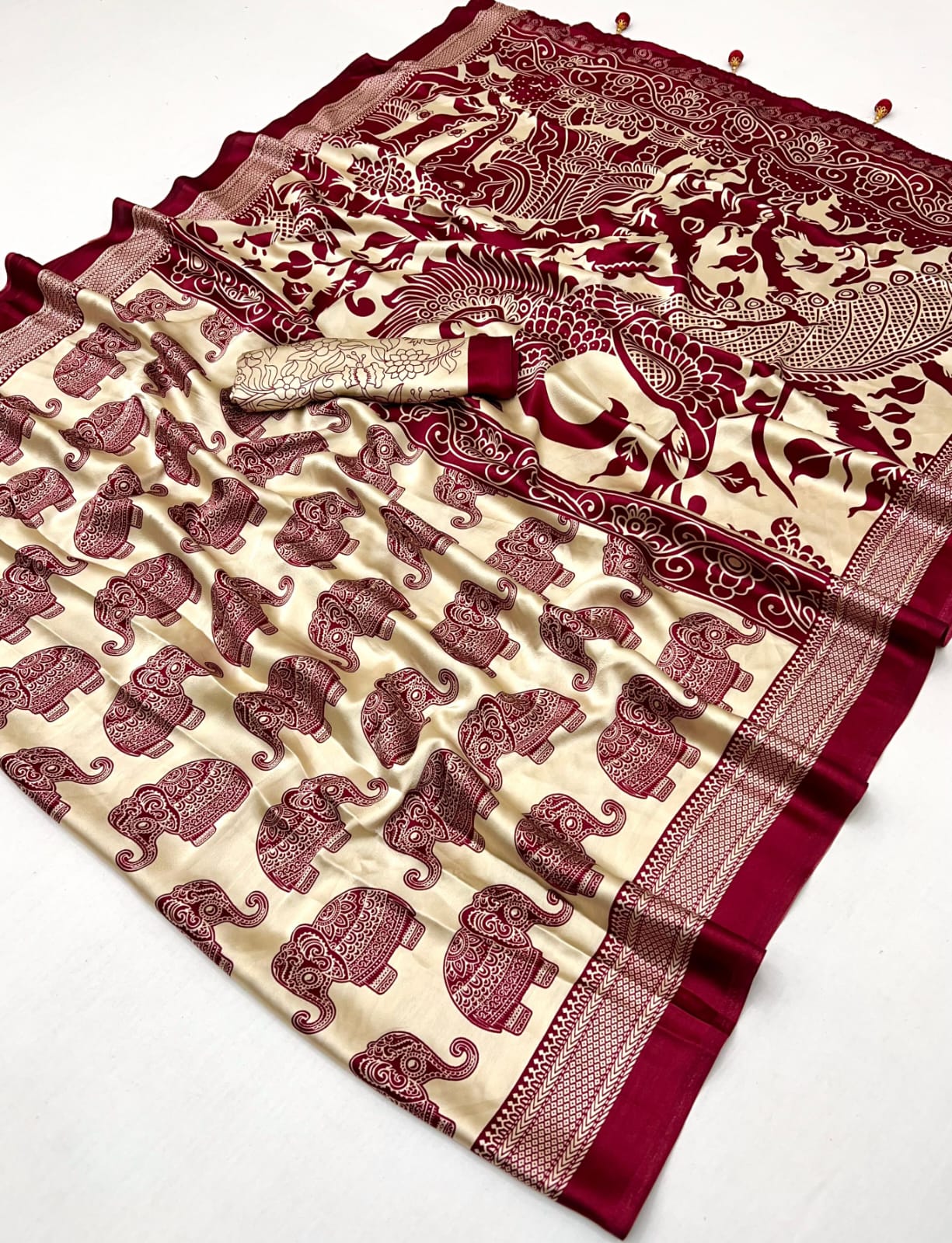 Saree with maroon and beige pattern on a white background