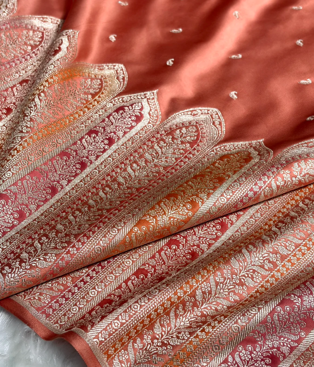 Close-up of a folded fabric with intricate patterns and embroidery.