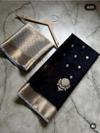 Two embroidered fabrics on a textured surface