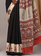 Black saree with red and white patterned border