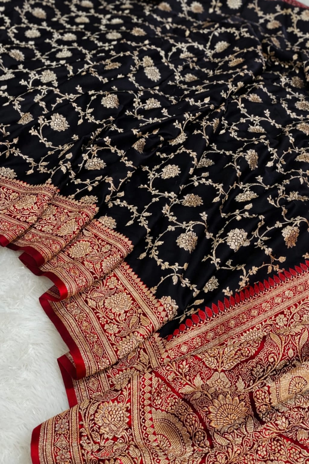 Black fabric with gold floral patterns and red border on a white background