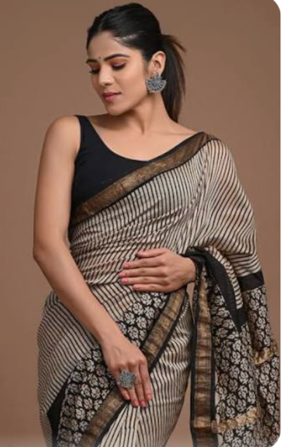 Woman wearing a saree with a plain background