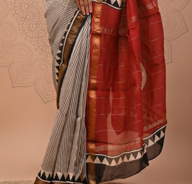 Traditional saree with a red and black pattern on a beige background