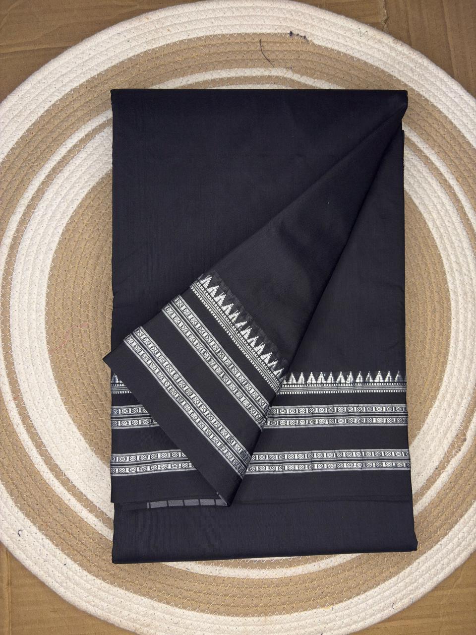 Black fabric with white geometric patterns on a circular wooden surface