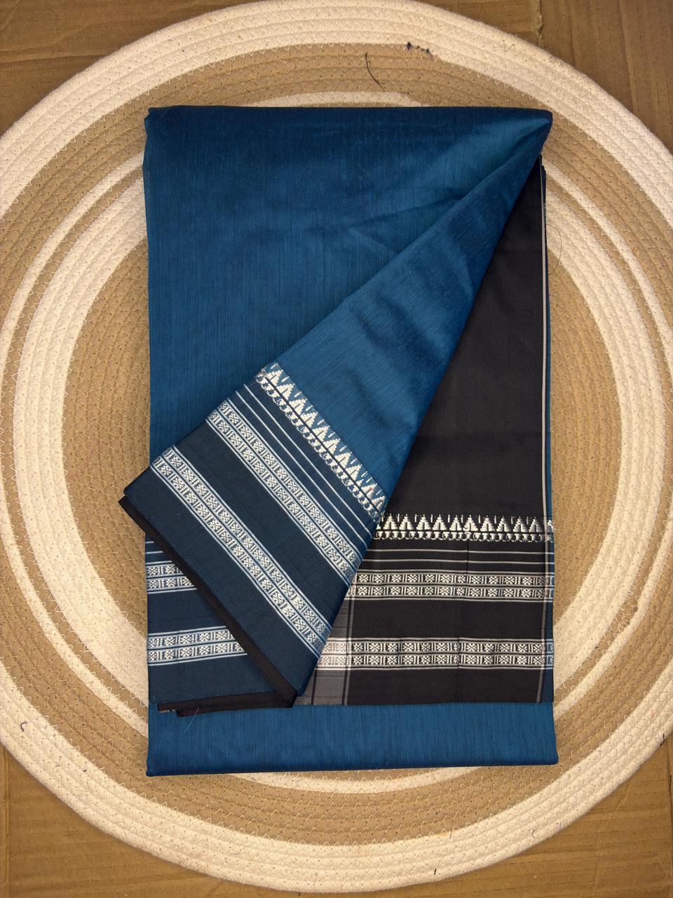 Folded blue fabric with patterns on a circular woven mat