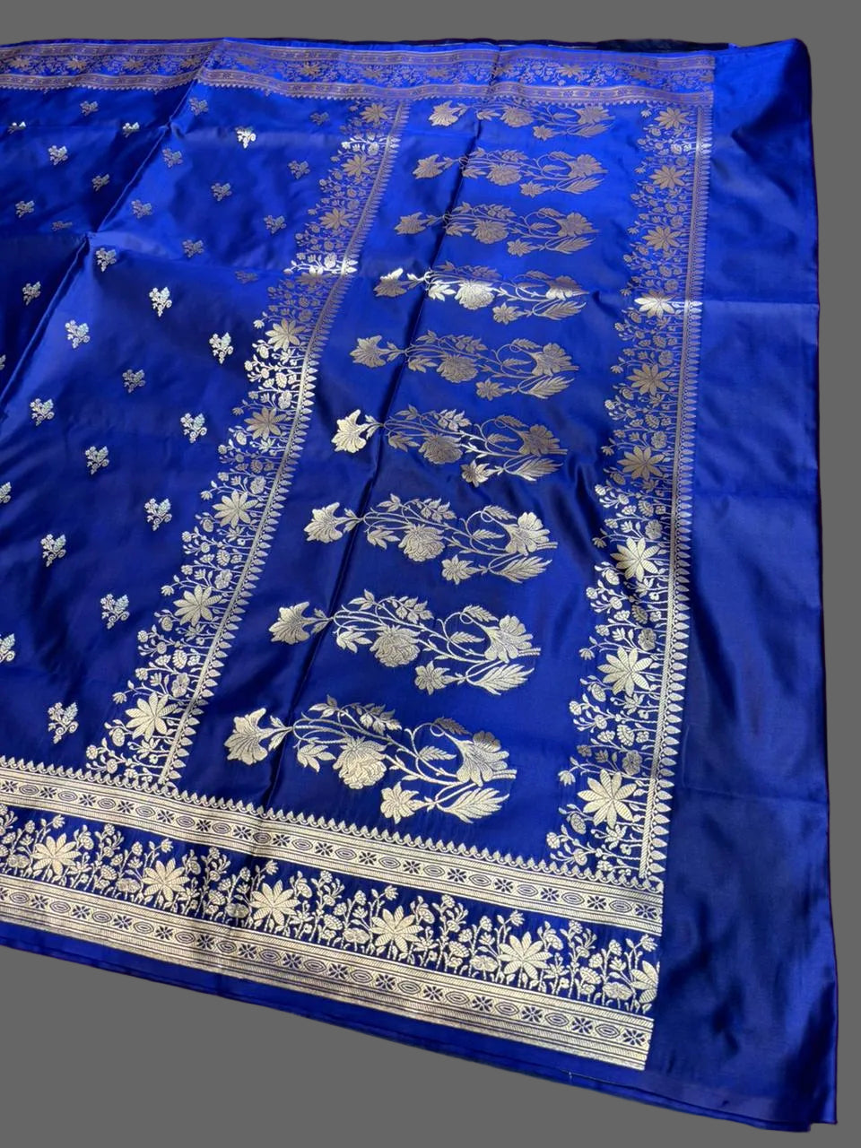 Blue fabric with white floral patterns on a wooden surface