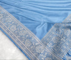 Light blue fabric with intricate patterns on a white background