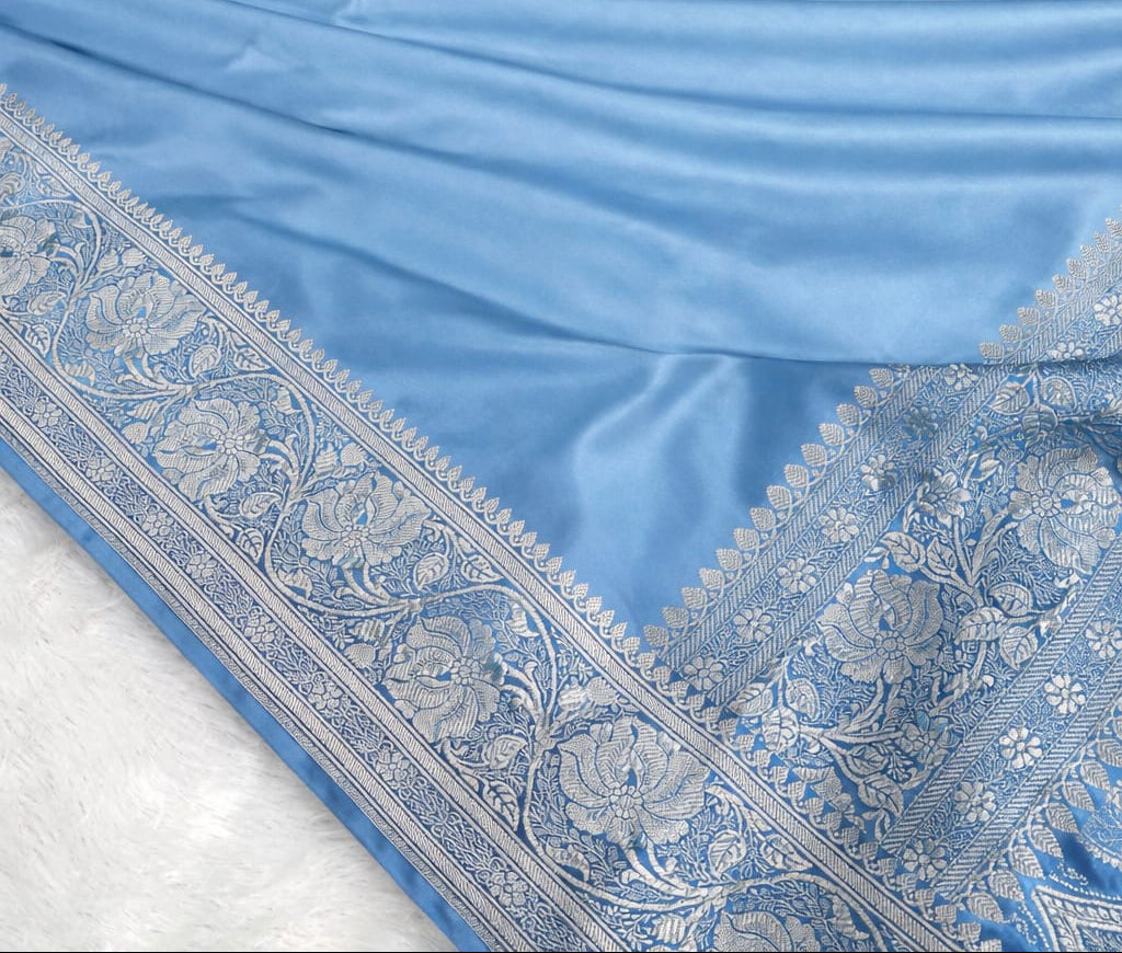 Light blue fabric with intricate patterns on a white background