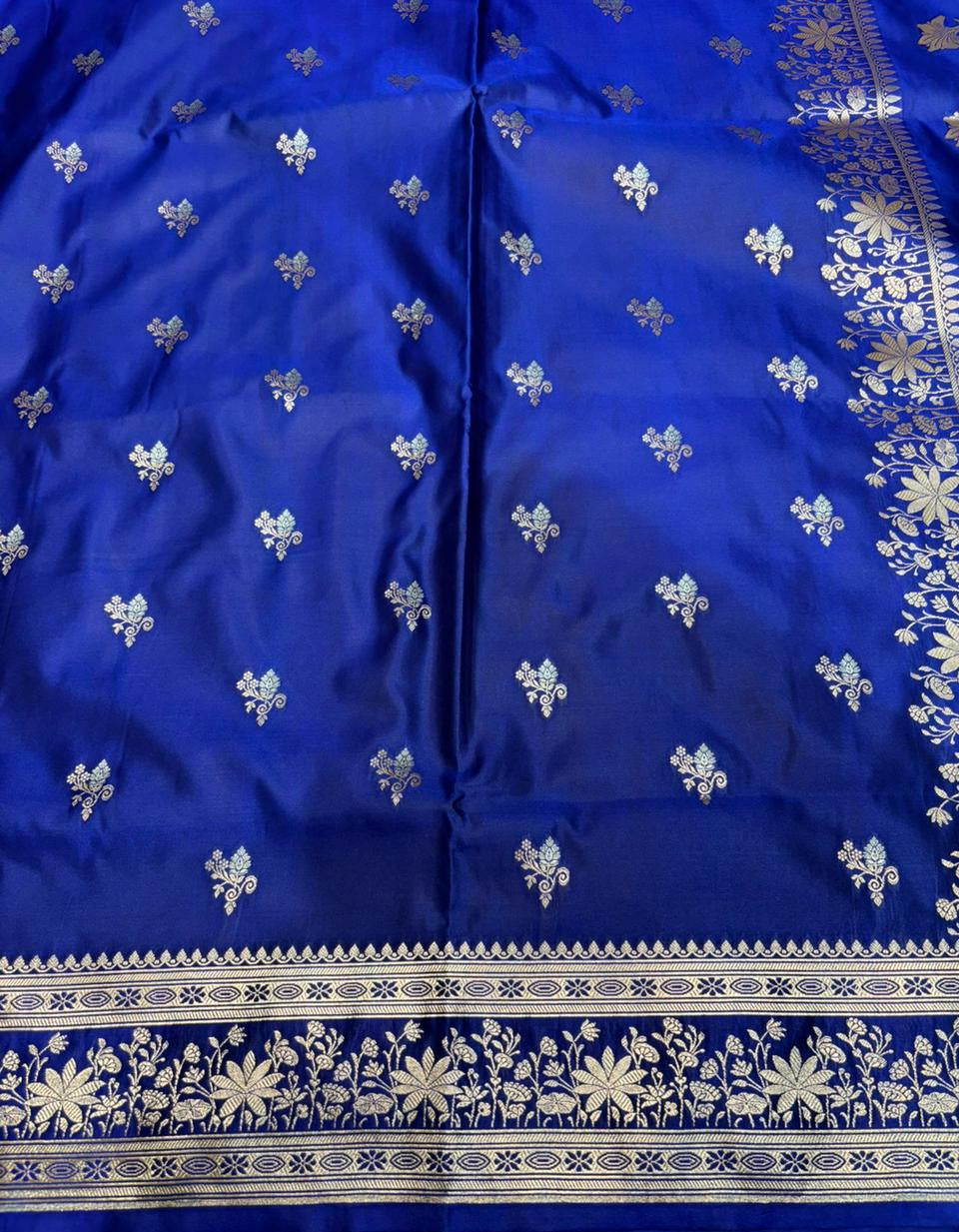 Blue fabric with white floral patterns and a border