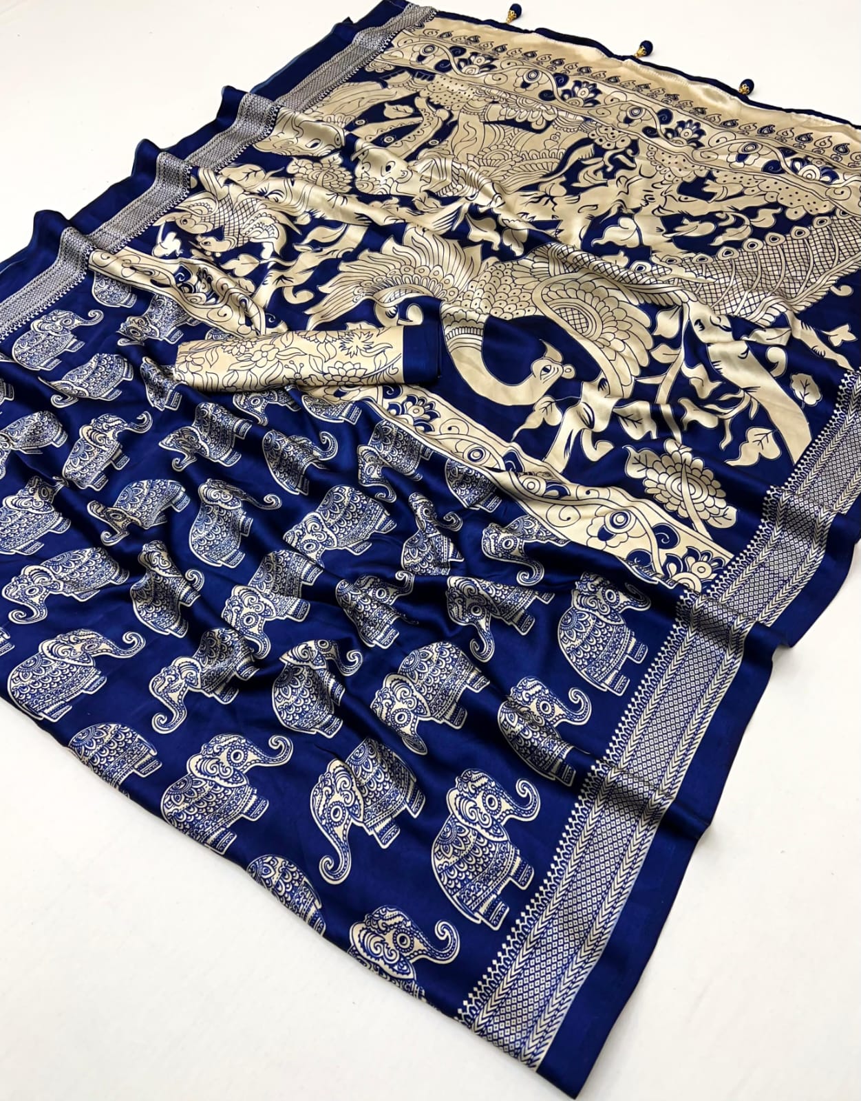 Blue saree with gold and white patterns on a white background