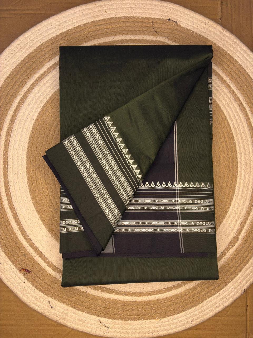 Green fabric with white patterns on a circular wooden surface