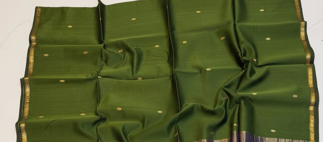 Green and blue saree with a decorative basket on a white background