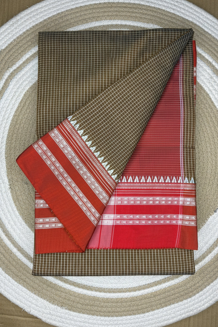 Folded fabric with brown and red patterns on a circular woven mat background