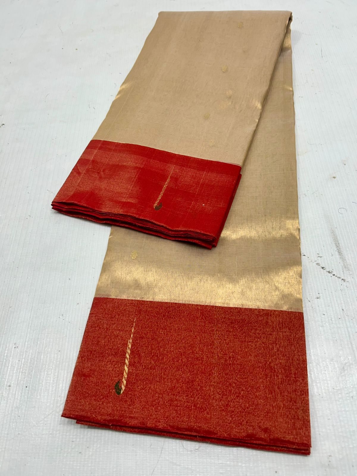 Gold and red chanderi saree with gold border on a white background