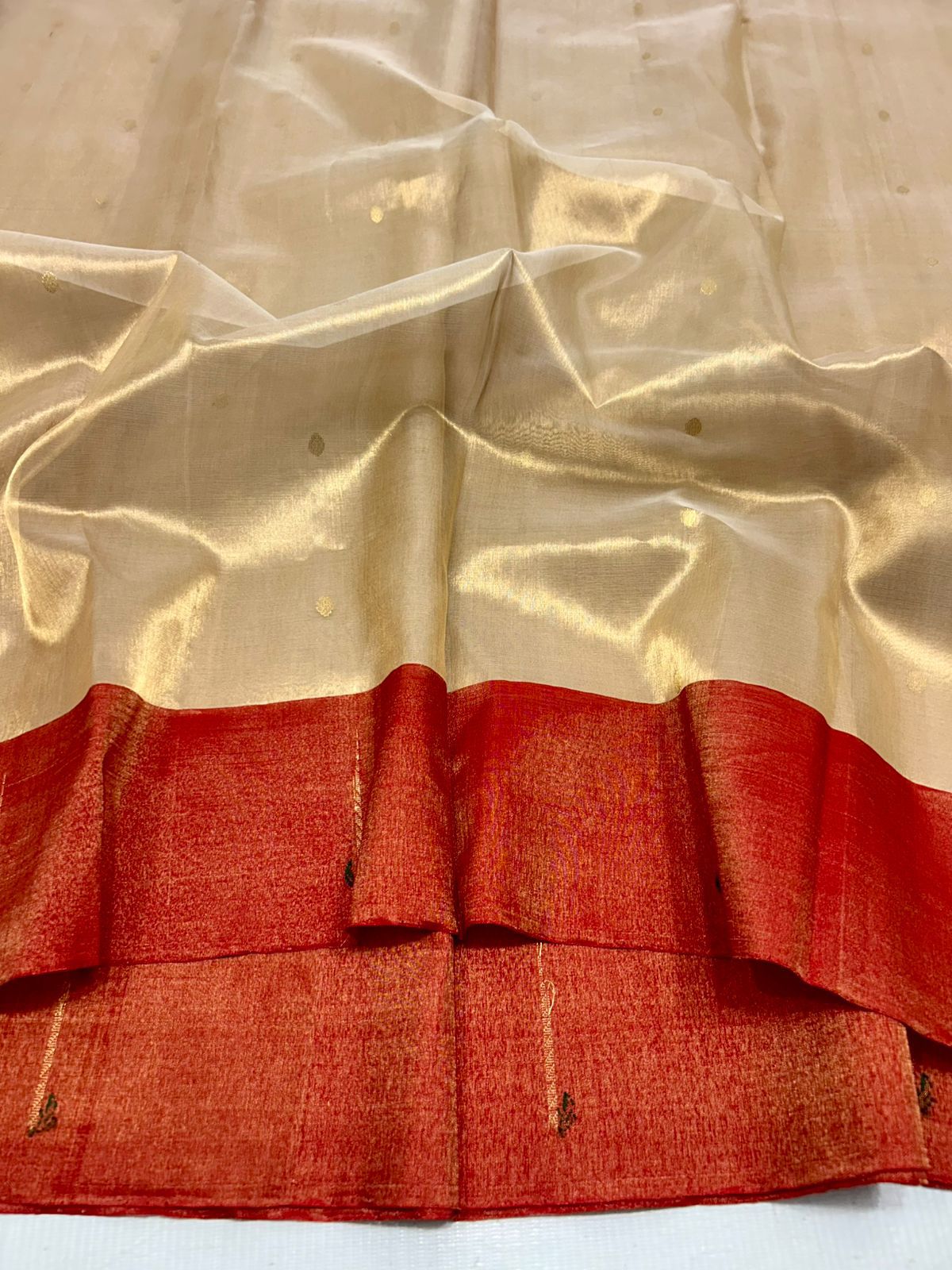 Chanderi saree with a red border on a white background