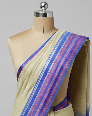 Beige saree with blue and pink border on a mannequin against a gray background