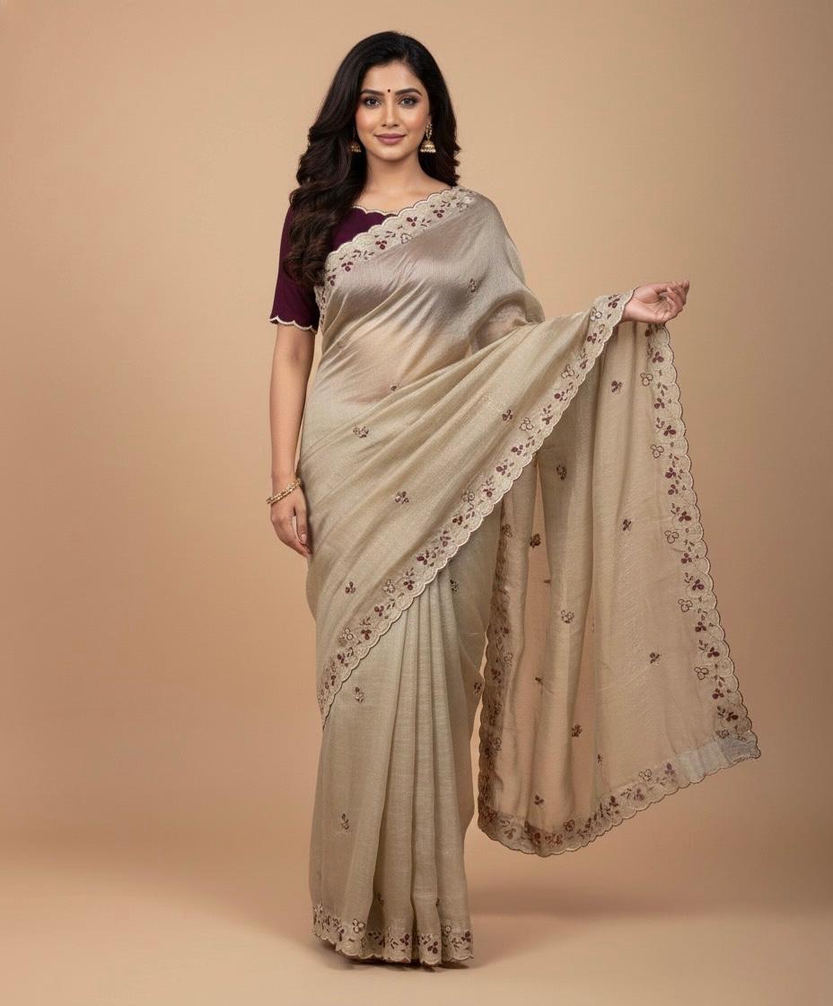 Woman wearing a beige saree with floral patterns on a beige background