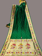 Green saree with floral patterns on a colorful background