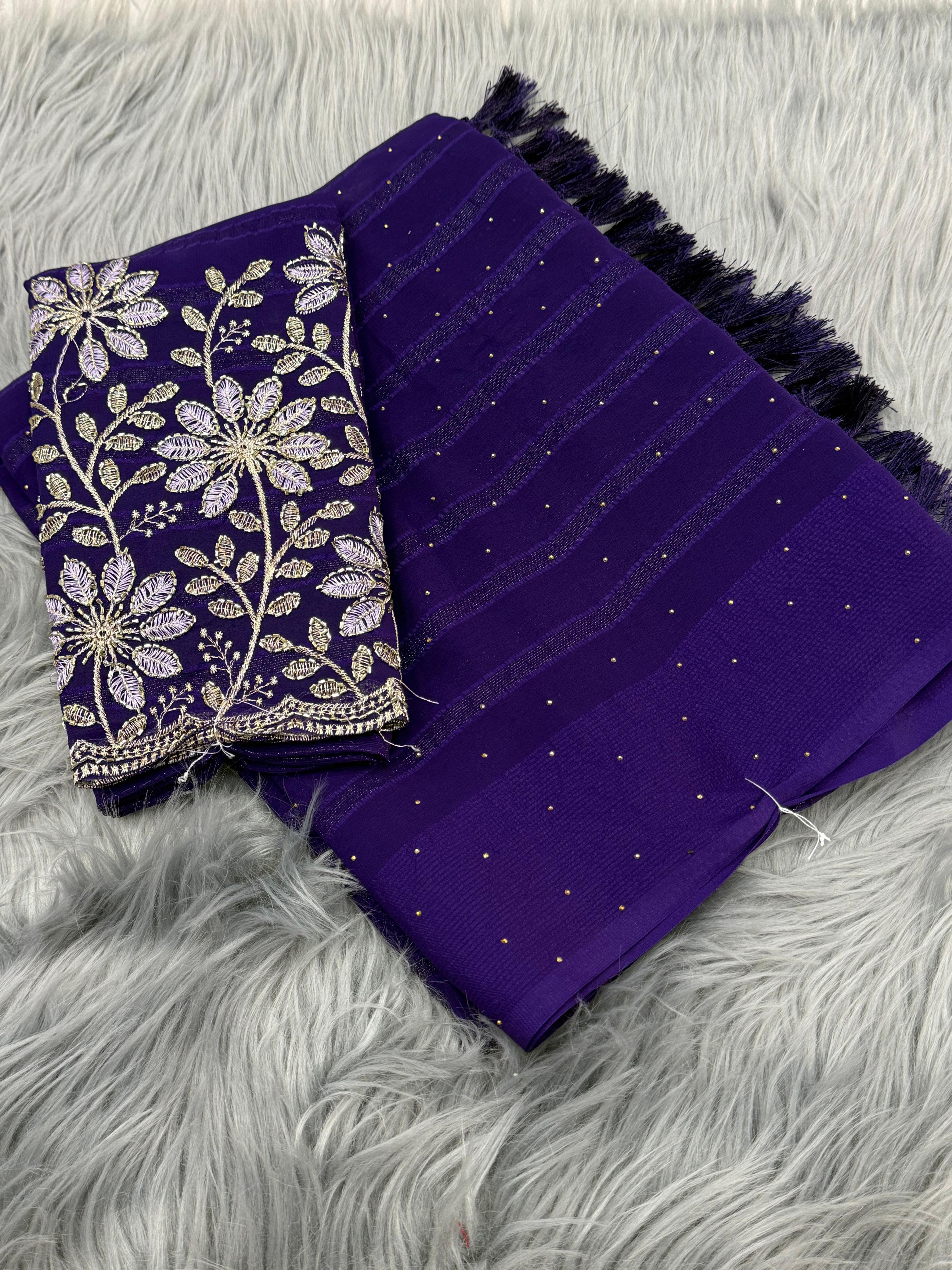 Purple fabric with floral embroidery on a gray textured surface