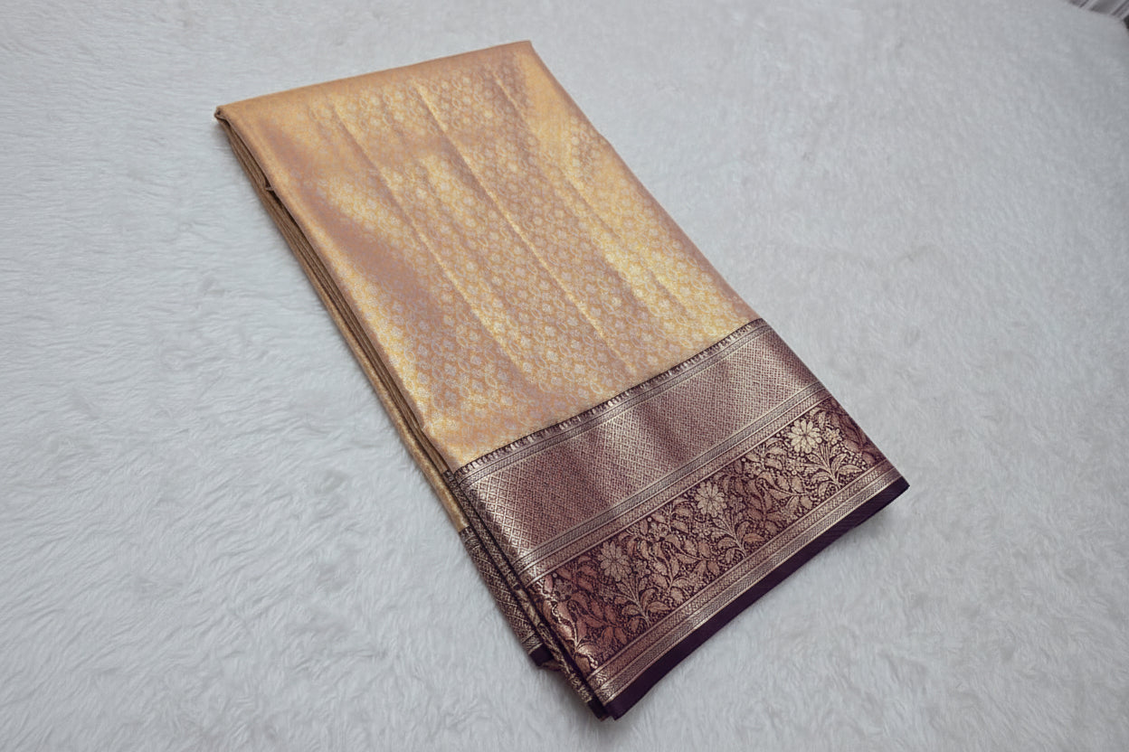 Beige saree with brown border on a light gray background