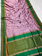 Saree with green and pink border on a white background