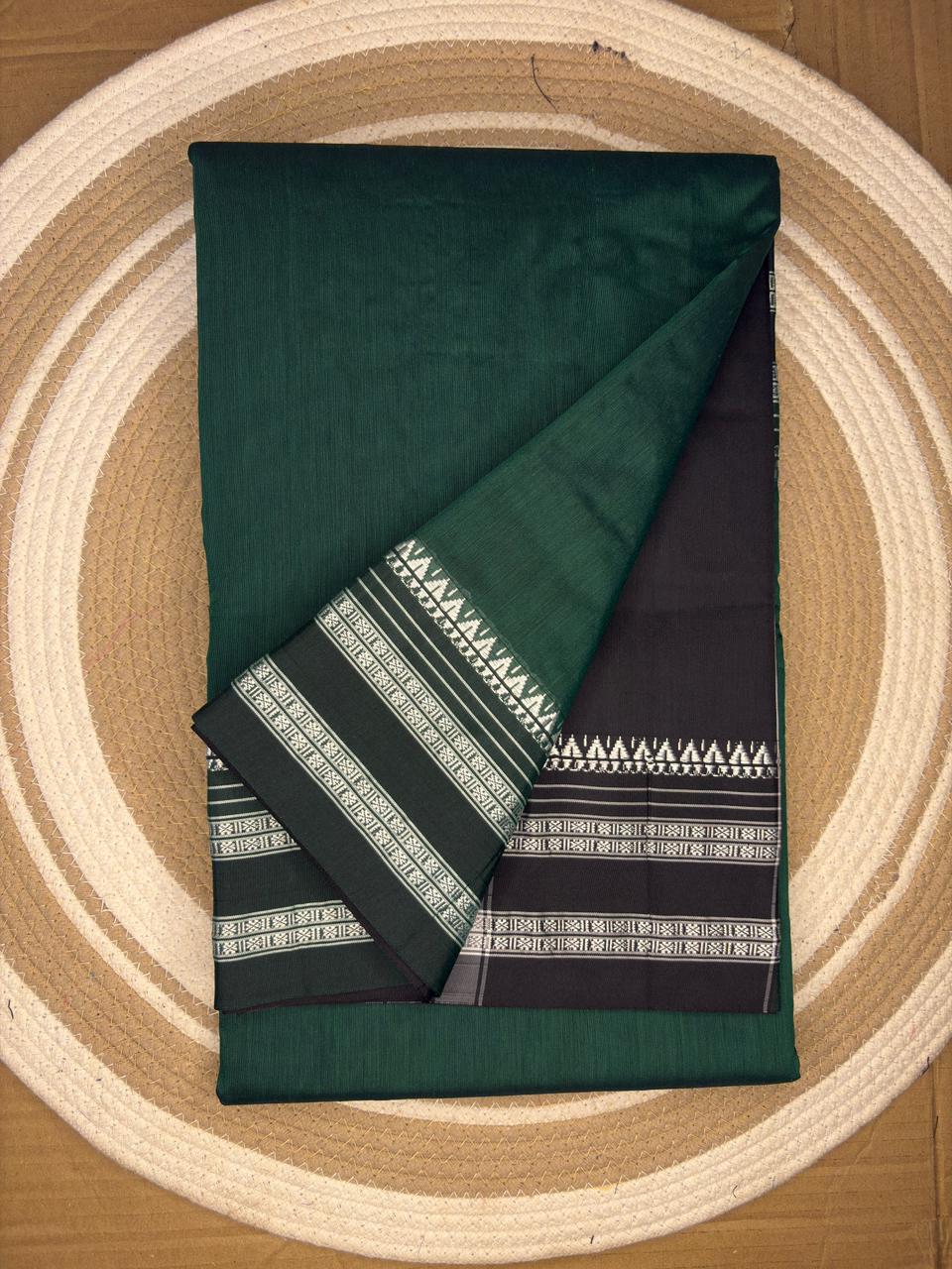 Folded green fabric with geometric patterns on a wooden surface