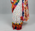 Saree with a colorful design on a mannequin against a gray background