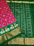 Green and pink saree with intricate patterns
