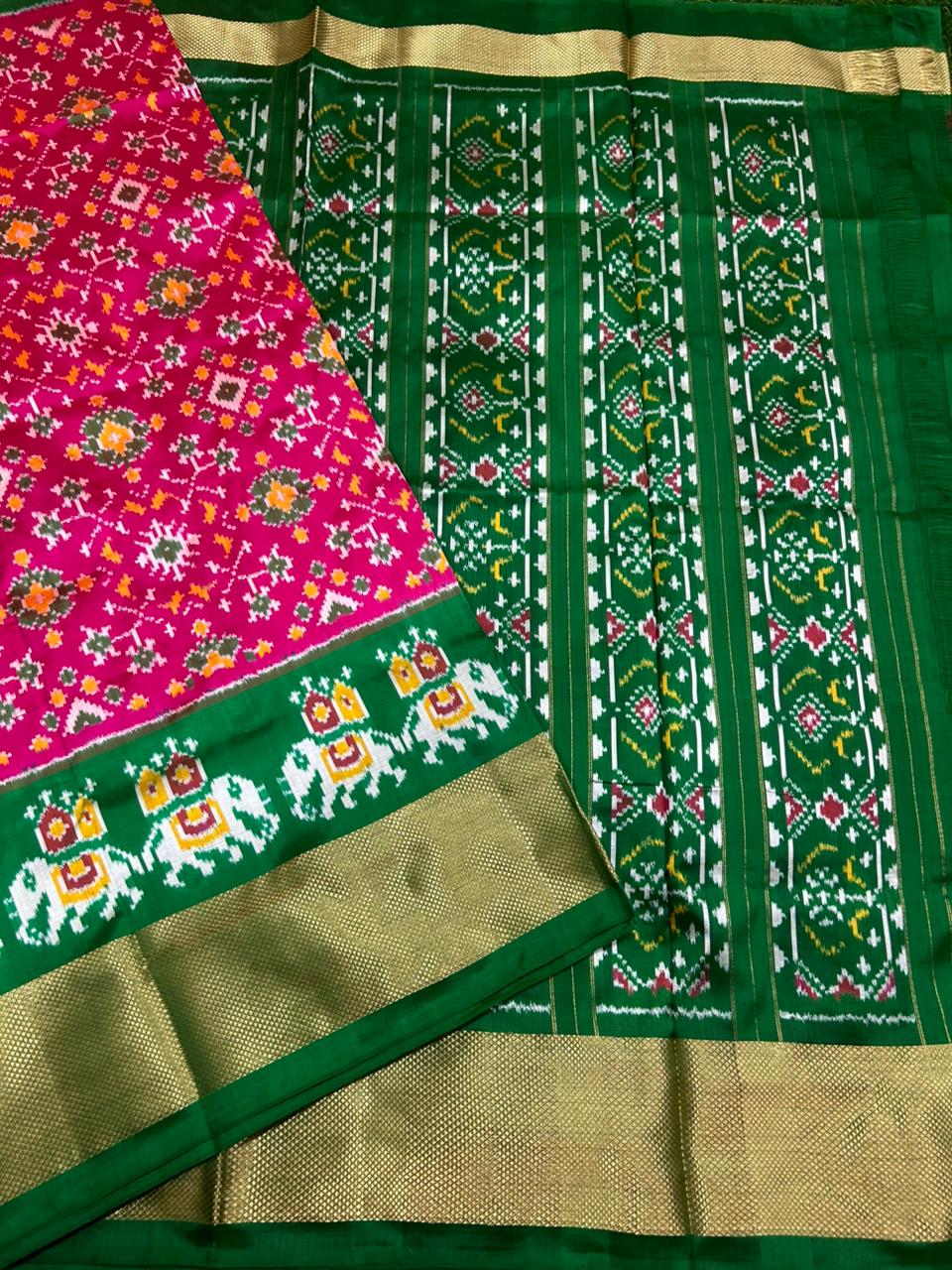 Green and pink saree with intricate patterns