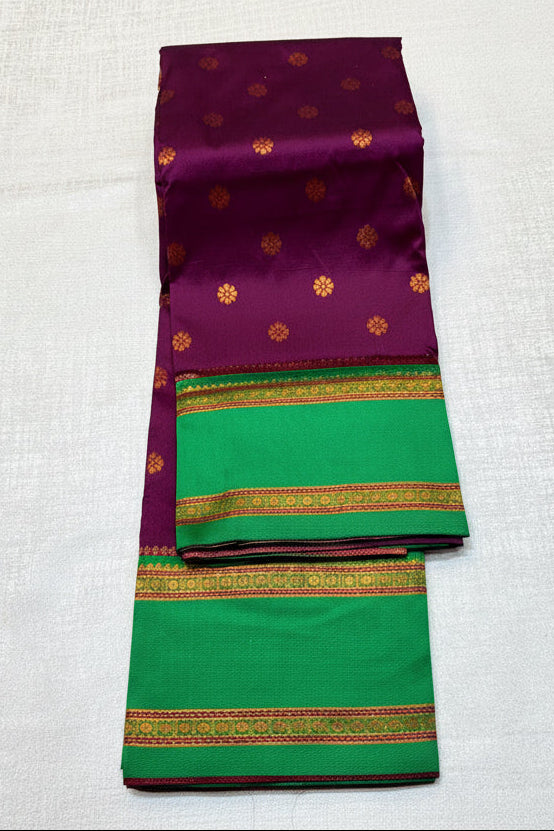 Purple and green saree with floral decorations on a white background